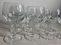 Side perspective of several clear wine glasses highlighting their shape, bowl size, and stem details.