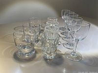 Full view of 13 shot glasses in three styles showing arrangement and detail of individual glasses.