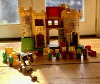 Wide shot of complete castle with figures, horse, and cart in front of window