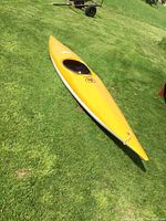 Side view of full kayak on grass