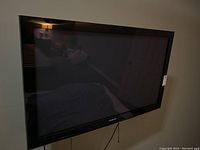 Front view of mounted TV showing screen and bezel