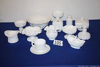 Photo showing the full set of 12 white milk glass items including bowls, compotes, candle sticks, sugar bowl, apothecary jar, cup and saucer.