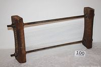 Full view of antique pasta chitarra mandolin featuring wooden frame and taut metal wires for pasta cutting.