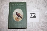 Front cover of the book showing green cloth binding with gold embossed text and oval bird illustration.