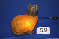 Front side view, light off, showing cat shape, metal head and base.