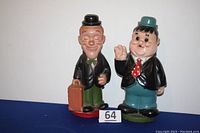 Front view of both Laurel and Hardy coin banks, showing full figure details and colors.