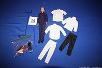 Full lot including vintage Dr. Ken, clothing pieces for physician outfit, stand, and accessories enclosed in a bag, plus blue golf club.