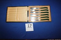 Six vintage tea or butter cutting knives with sterling silver bands and dark green plastic handles displayed in original fitted case lined with satin and felt.