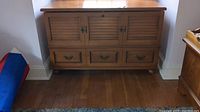 Front view of the Lane cedar chest showing three cabinet doors and three drawers.