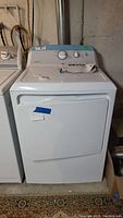 Front view of white Hotpoint electric dryer with control panel and door visible.