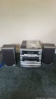 Full view of the stereo system with speakers on either side and manual on top