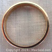 Top view centered on circular solid gold band showing smooth finish and round shape