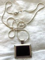 Full pendant and chain laid out showing pendant details and chain length