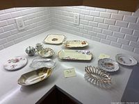 Photo of all china and glass plates and serving pieces on white countertop under bright lighting.
