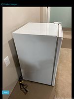 Side view of white mini fridge showing power cord and overall shape