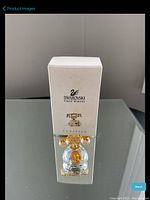 Full view of Swarovski box packaging with image of collectible telephone figurine and branding details.
