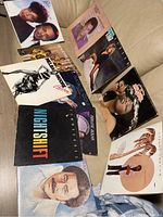 Photo showing ten vinyl record album covers including Charley Pride, Tina Turner, Nightshift, and others