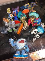 13 assorted Skylanders figures arranged closely on a black surface