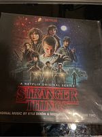 Front cover of Stranger Things vinyl LP showing main character portraits and title information.