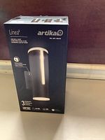 Front view of the Artika Linea LED Wall Light box showing product image and branding.