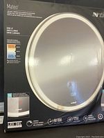 Front and box view of the Artika Mateo LED wall mirror with integrated defogger and edge-lit LED illumination.