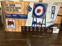 Full boxed set showing the target, axes, and storage stand along with graphics and text on the box.