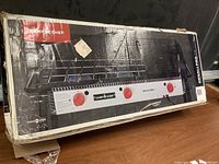 Sealed retail box front showing Camp Chef branding and three-burner cooktop illustration