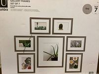 Photo showing all 7 gallery frames arranged on a wall with sample photos inside