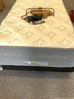 Full view of twin mattress top showing quilted surface, remote, adapter and boxed legs