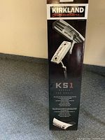 Photo of the original box prominently showing Kirkland Signature branding and KS1 model details.