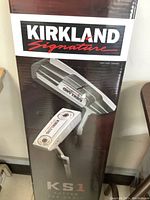 Photo of Kirkland Signature KS1 putter box, showing branding and product image on box.