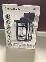 Box front showing Good Earth branding and key features such as built-in sensor, LED bulb, and outdoor suitability