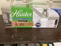 Front of Hunter ceiling fan box showing brand, blade diameter, and finish.