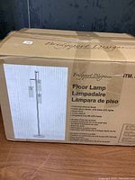 Photo of boxed Bridgeport Designs floor lamp with product image and features printed on box