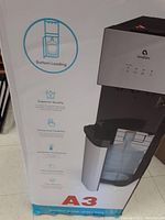 Front of boxed Avalon A3 bottom loading water cooler showing features and branding