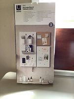 Photo of product box featuring assembled peg board set with various accessories displayed on boards.