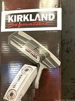 Front of box showing Kirkland Signature KS1 putter image and branding.