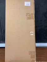 Sealed cardboard box containing the bed cushion.