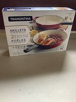 Original box front showing 2-piece set of Tramontina enameled cast iron skillets in bright red.