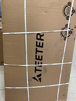 Large cardboard box with Teeter branding and strapped packaging