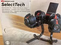 Front of sealed retail box showing Bowflex SelectTech 552 dumbbells on stand with media rack