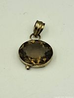 Front view of the smokey quartz pendant showing faceted stone and silver bezel setting with bail