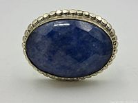 Close-up of the ring's top showing the large oval blue stone set in a textured sterling silver bezel.