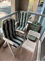 Photo showing 5 patio chairs with cushions in outdoor balcony setting