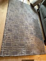 Full view of the Anglo Oriental rug showing geometric rectangular pattern in beige and taupe shades.