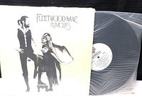 Front cover of Fleetwood Mac Rumours vinyl record album showing two band members with title text.
