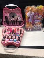 Full view of the Barbie makeup kit open showing all included makeup toy items