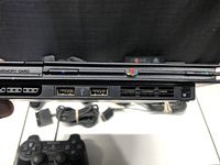Front side of PS2 console showing two memory card slots, two controller ports and dual USB ports.