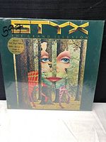 Front cover of Styx The Grand Illusion album with special gold vinyl edition sticker visible.