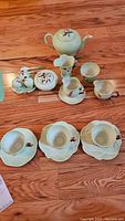Full set of Carlton Ware tea items including teapot, three cups with saucers, creamer, sugar bowl, salt and pepper shakers.